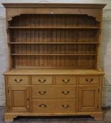 Pine Dresser, Having open shelving above four small drawers and two long drawers, flanked with a