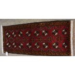 Turkoman Prayer Mat, Decorated with eight rows of two geometric motifs on a red ground, 98cm x 43cm