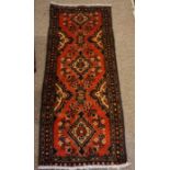 Hamadan Runner, Decorated with geometric motifs on a red ground, 140cm x 60cm