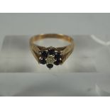 9ct Gold Gem Set Ladies Ring, Set with a small diamond style stone, surrounded with six small