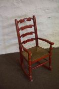 Childs Red Painted Rocking Chair, Having a woven seat, 79cm high