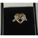 14ct Gold Ruby Ladies Ring, Set with a small ruby to the centre, flanked with small diamond style