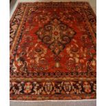 Persian Carpet, Decorated with allover floral medallions on a red ground, 330cm x 262cm