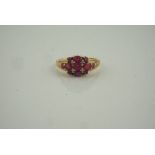 9ct Gold Gem Set and Diamond Ring, set with graduated ruby coloured stones, flanked with diamond