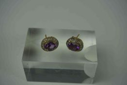 Pair of 9ct Gold Amethyst & Diamond Earrings, Set with an oval Amethyst cabochon, Surrounded by