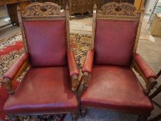 Pair of Late Victorian Carved Oak Parlour Armchairs, Upholstered in later red Rexine, Raised on