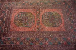 Afghan Bluch Rug, Decorated with Geometric medallions on a red ground,129cm x 83cm