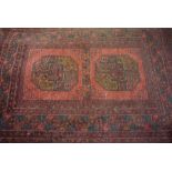 Afghan Bluch Rug, Decorated with Geometric medallions on a red ground,129cm x 83cm