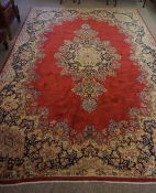 Persian Carpet, Decorated with Floral medallions on a red ground, 252cm x 362cm