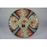 Japanese Imari Charger, circa late 19th century, Decorated with panels of Buddhist children, Urns