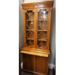 Modern Yewwood Bookcase, Having two glazed Astragal doors enclosing a shelved interior, Above a