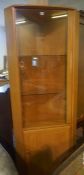 Ercol Windsor Corner Cabinet, Having a glazed door, Enclosing fitted glass shelves, Above a cupboard