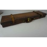 Tan Leather and Oak Gun Case, circa 19th century, Decorated with Brass mounts, Having a red Baise