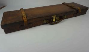 Tan Leather and Oak Gun Case, circa 19th century, Decorated with Brass mounts, Having a red Baise