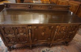 Jacobean Style Oak Sideboard, Having a pediment above three doors, Enclosing a shelved interior,