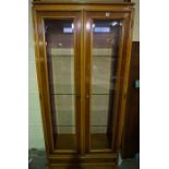 Modern Glazed Display Cabinet, Having two glazed doors enclosing glass shelves, Above a drawer,