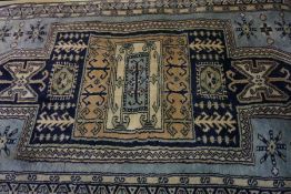 Afghan Rug, Decorated with Geometric medallions on a blue ground, 163cm x 99cm