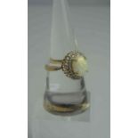 9ct Gold Opal and Diamond Ladies Ring, Set with a large opal to the centre, surrounded by diamond