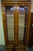 Modern Glazed Display Cabinet, Having two Glazed Doors enclosing Glass shelves, Above a Drawer,