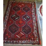 Persian Shiraz Rug, Decorated with three rows of two Geometric Medallions on a Red ground, 270cm x