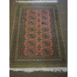 Pakistani Rug, Decorated with seven rows of two Geometric Medallions on a Pink ground, 150cm x 99cm