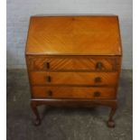 Vintage Writing Bureau, Having a Fall Front above three Drawers, Raised on Ball and Claw supports,