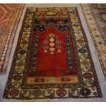 Old Turkish Rug, Decorated with Geometric and Floral Medallions on a Red ground, 175cm x 107cm