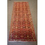 Hamadan Runner, Decorated with allover Geometric Medallions on a Red ground, 190cm x 76cm
