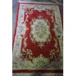 Chinese Style Rug, Decorated with Floral Motifs and Medallions on a Red ground, 195cm x 125cm