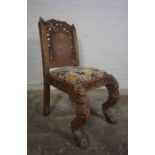 Burmese Carved Hall Chair, circa late 19th / early 20th century, Decorated with Grotesque masks