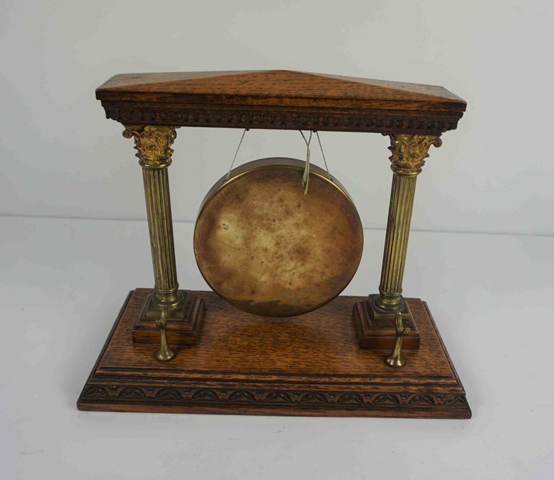 Oak and Brass Dinner Gong, 26cm high, 32.5cm wide, 15.5cm deepCondition reportThe age is
