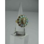 9ct Gold Opal and Diamond Flowerhead Ring, Set with a large opal to the centre, flanked with