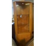 Ercol Windsor Corner Cabinet, Having a glazed door, enclosing fitted glass shelves, above a cupboard