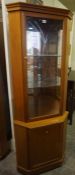 Teak Style Corner Cabinet, Having a glazed door enclosing a shelved interior, Above a Cupboard door,