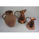 Two Graduated Copper Measuring Jugs, 22cm high, 30cm high, Also with a Terracotta Jug, (3)