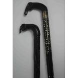 Two African Carved Ebony Walking Sticks, Both having Elephant handles, One having a Silver collar,