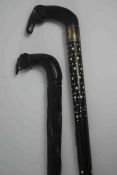 Two African Carved Ebony Walking Sticks, Both having Elephant handles, One having a Silver collar,