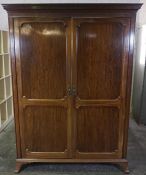 Mahogany Wardrobe, circa early 20th century, Having A Dentil Cornice above two Doors, Raised on