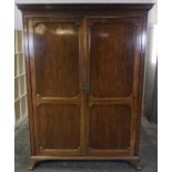 Mahogany Wardrobe, circa early 20th century, Having A Dentil Cornice above two Doors, Raised on