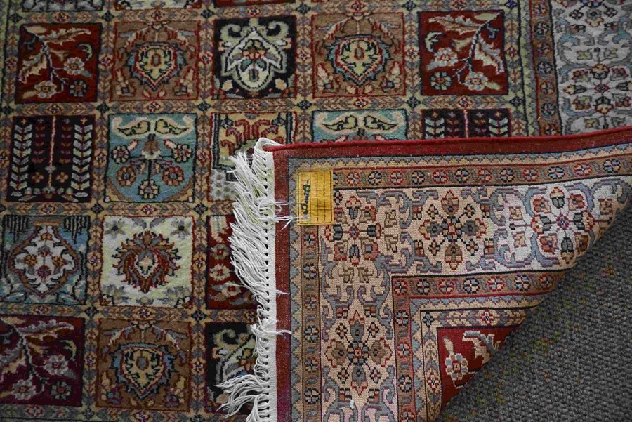 Indian Kashmir Rug, Decorated with ten rows of five Floral and Geometric Medallions on a Red ground, - Image 3 of 3