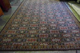 Wilton Carpet, Decorated with allover Geometric Medallions on a Red, White and Blue Ground, 370cm