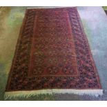 Afghan Rug, Decorated with eleven rows of three Geometric Medallions on a Red ground, 210cm x 126cm,