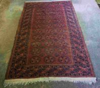 Afghan Rug, Decorated with eleven rows of three Geometric Medallions on a Red ground, 210cm x 126cm,