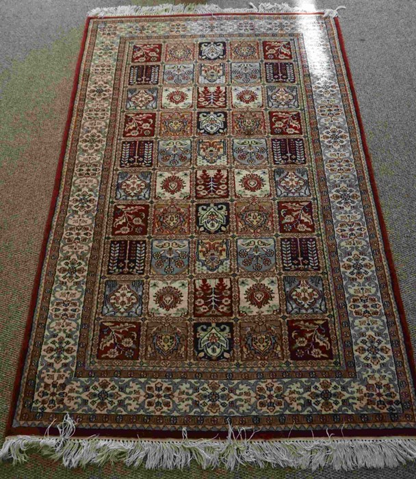 Indian Kashmir Rug, Decorated with ten rows of five Floral and Geometric Medallions on a Red ground,