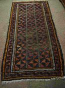 Afghan Bluch Rug, Decorated with allover Geometric Medallions on a Red, Black and Orange Ground,