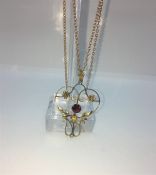 Art Nouveau Style Ruby and Yellow Metal Pendant, Set with a Ruby to the centre, On an unmarked 9ct