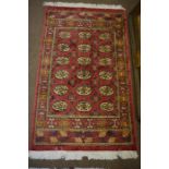 Pair of Persian Rugs, Decorated with six rows of three Geometric Medallions on a Red Ground, 160cm x