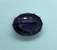 Amethyst Faceted Cut Brooch, Set with an oval Amethyst Cabochon, Measuring approximately 20mm,