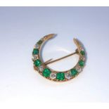 Emerald and Diamond Crescent Brooch, Set with approximately 9 Graduated Brilliant cut Diamonds,