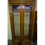 Modern Glazed Display Cabinet, Having two Glazed Doors enclosing Glass shelves, Above a Drawer,